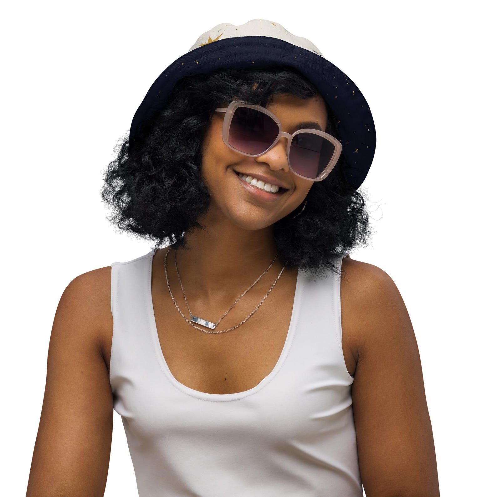 Model smiling in the reversible bucket hat with the dark star-field side turned outward