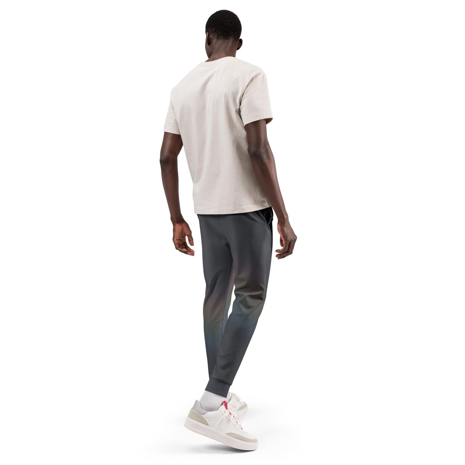 Back view of Quiet Spectrum joggers showing the colour field shifting toward green and plum across the dark fabric