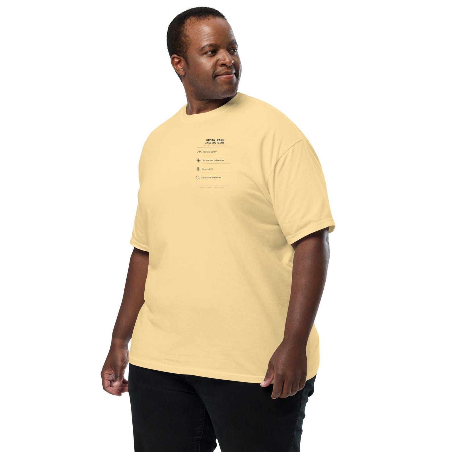 Model wearing the pale yellow Human Care Instructions T-shirt in a regular unisex fit