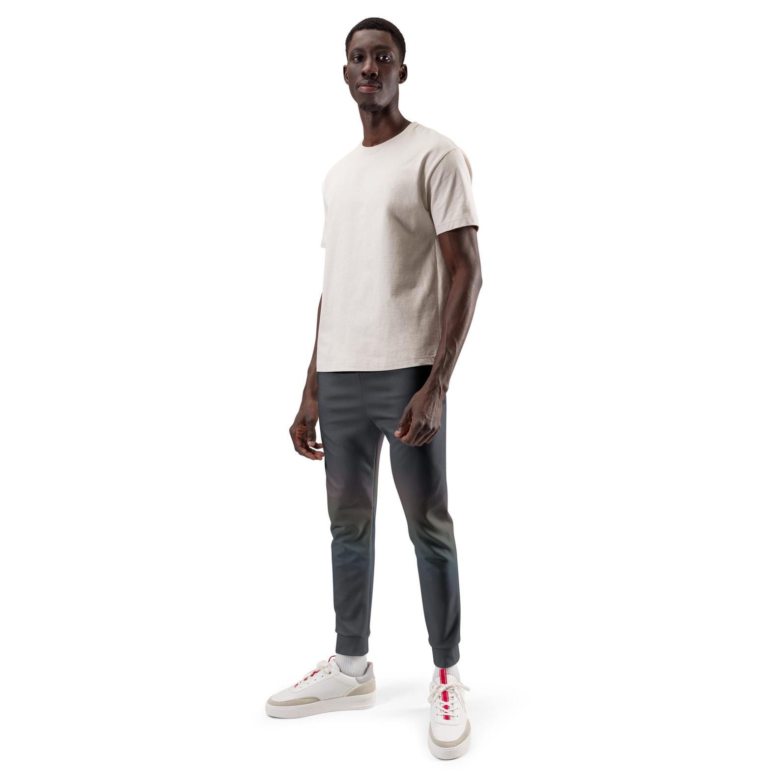 Model standing in dark Quiet Spectrum joggers with a faint diagonal field of softened colour across the legs