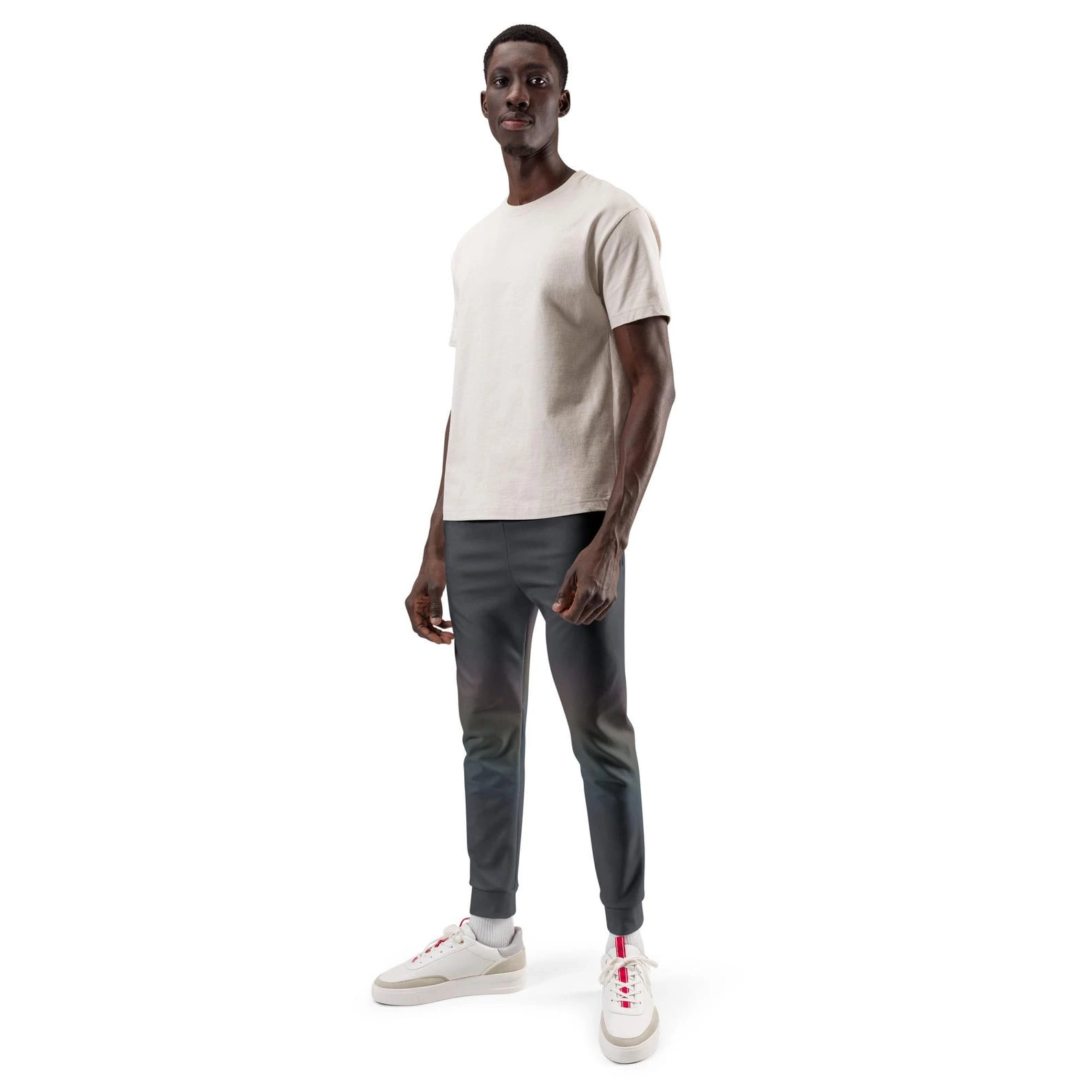 Model standing in dark Quiet Spectrum joggers with a faint diagonal field of softened colour across the legs