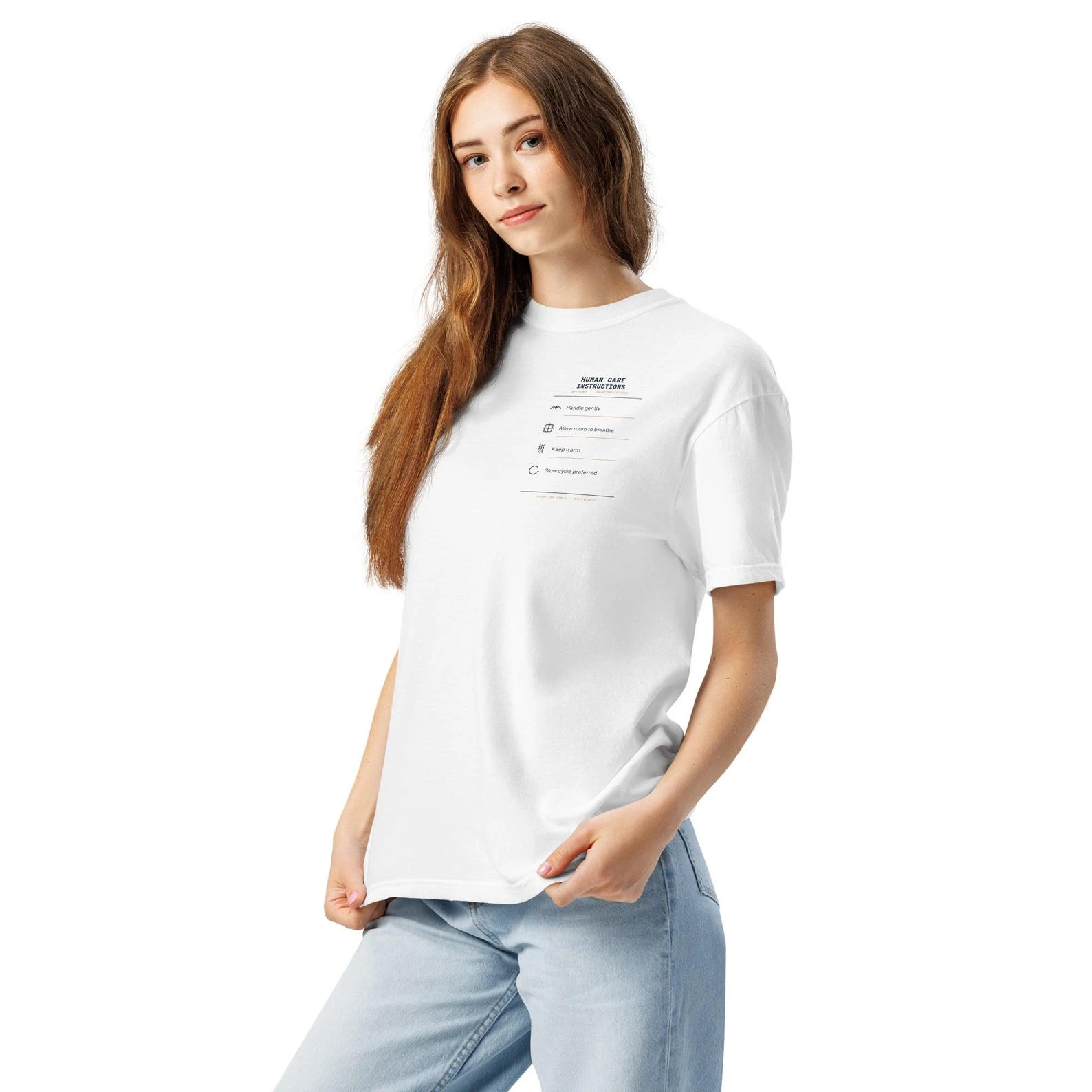 Model wearing a white Human Care Instructions T-shirt with a small care-label design over the left chest