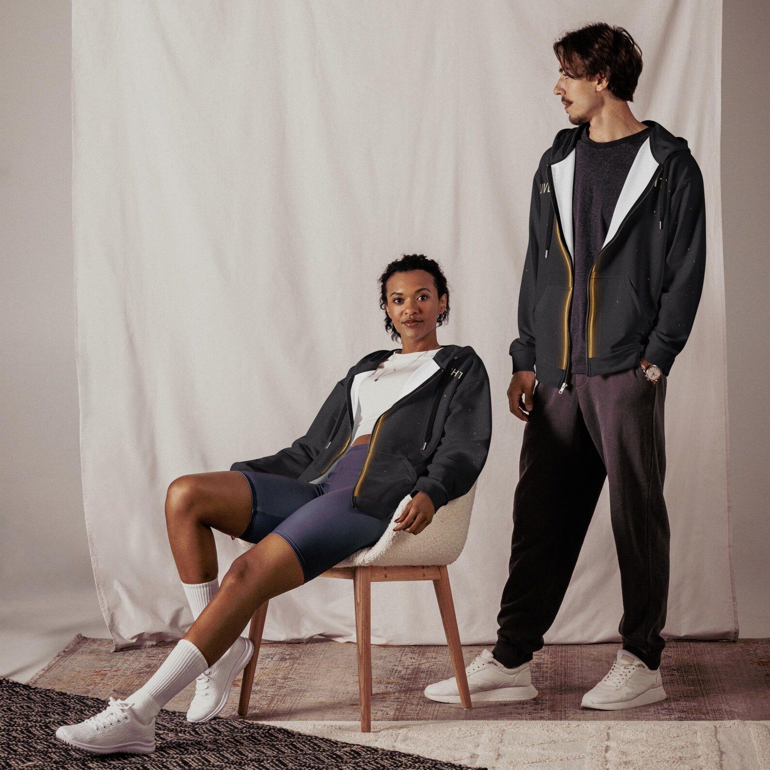 Two models both wearing the Live Light hoodie