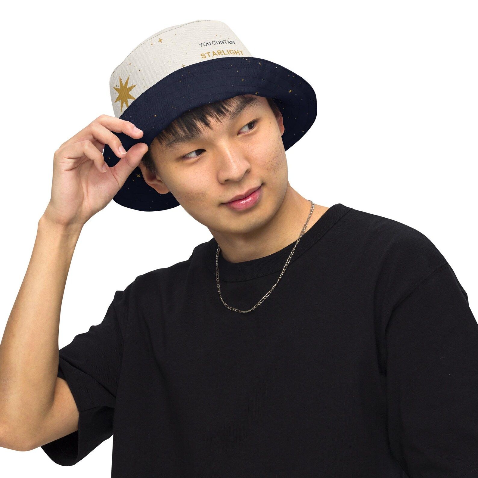 Model smiling in the reversible bucket hat with the white star-field side and a part of the dark underside